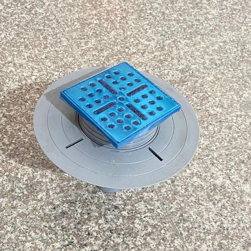 Vue de dessus bonde verticale DINO pour receveurs à carreler Ø90 avec grille en acier inoxydable